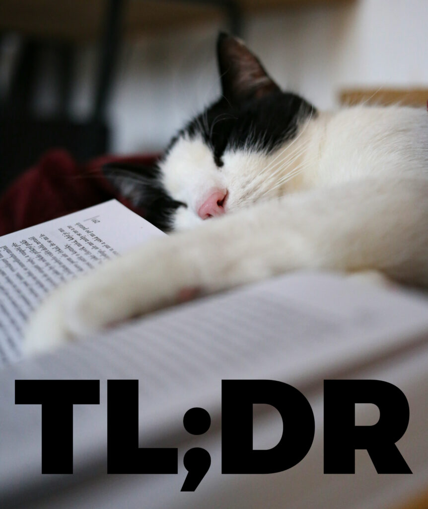 A sleeping cat with its paw stretched out along the center of an open book. Added text reads: TL;DR.