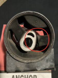 A close-up of the van's front motor mount, showing one 'arm' of the rubber insides split apart from the metal casing.